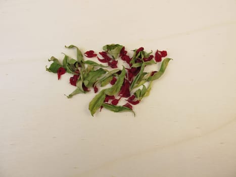 Dried pomegranate leaves and dried pomegranate flowers on a wooden board