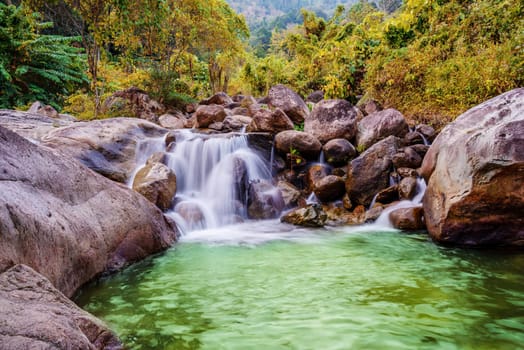 River stone and waterfall, View water river tree, Stone river in multi color tree leaf in forest