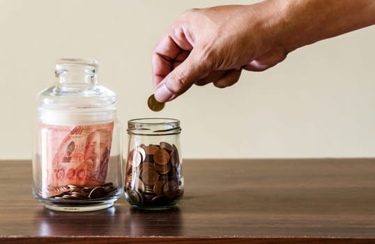 Save money and account banking for finance business concept, Coin money in bottle on business office table, Savings for retirement and investing concept