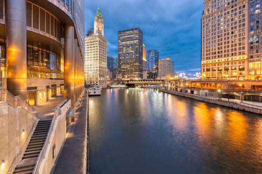 City of Chicago downtown and Chicago River sunset night in Chicago Illinois USA.