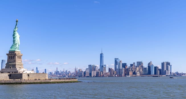 Statue of Liberty with Manhattan downtown  Skylines building in background, New York City , NYC USA.