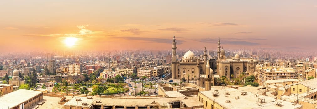 Mosque-Madrassa of Sultan Hassan in the sunset panorama of Cairo, Egypt.