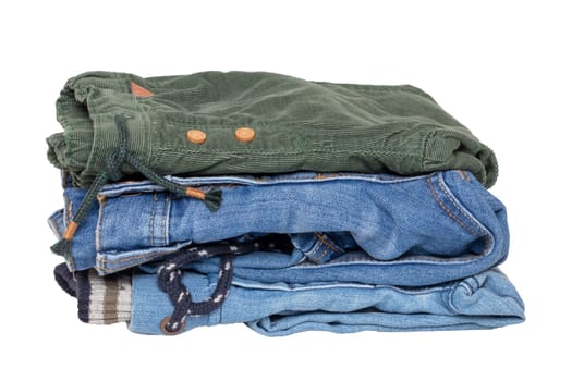 Stack of jeans clothes. Close-up of a stack of jeans for kids isolated on a white background. Denim fashion for children. Macro.