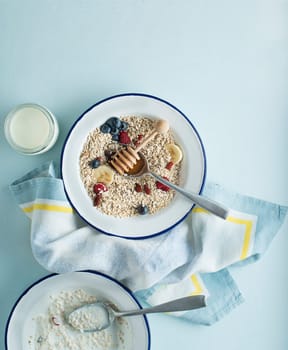 Porridge bowl oatmeal with fruits, berries, and honey. Concept of healthy breakfast, wellbeing, healthy eating, dieting and weight loss