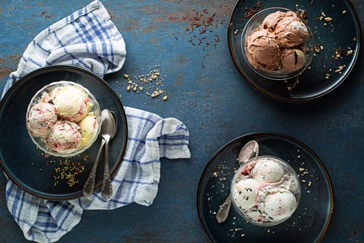 Set of ice cream scoops of different colors and flavours with berries, nuts and fruits