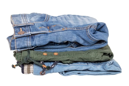 Stack of jeans clothes. Close-up of a stack of jeans for kids isolated on a white background. Denim fashion for children. Macro.