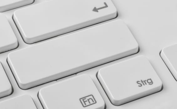 A keyboard with an unlabeled button
