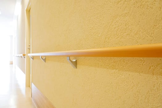 Walkway in the building with railing on white wall