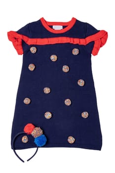 Clothes for children. A beautiful blue sleeveless dress with red collar, ruffles and with fluffy fabric balls and a hairband isolated on a white background. Little girl autumn and spring fashion.