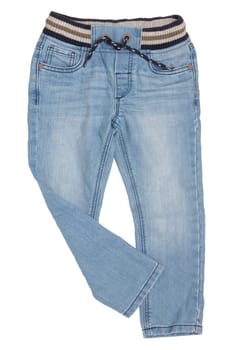 Fashionable denim clothes. Trendy blue jeans trousers with ribbon bow isolated on a white background. Right trouser leg folded. Fashionable jeans for child boy.