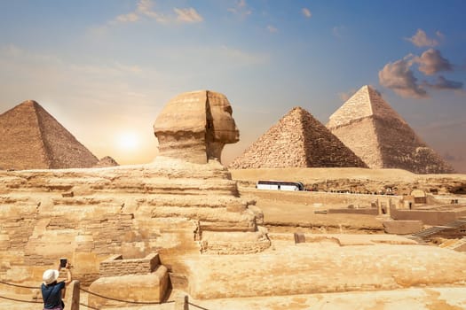 A tourist in Giza enjoying the Sphinx and the Pyramids, Egypt.
