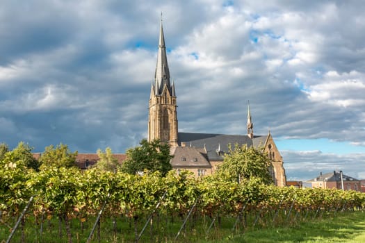 Catholic Church Edenkoben Germany Rhineland Palatinate with fountain and cloudy blue sky