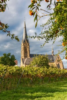 Catholic Church Edenkoben Germany Rhineland Palatinate with fountain and cloudy blue sky