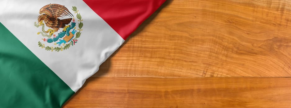 National flag of Mexico on a wooden background with copy space