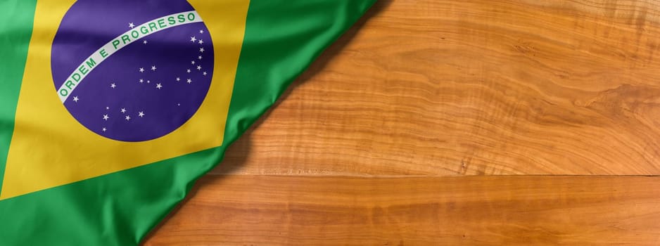 National flag of Brazil on a wooden background with copy space