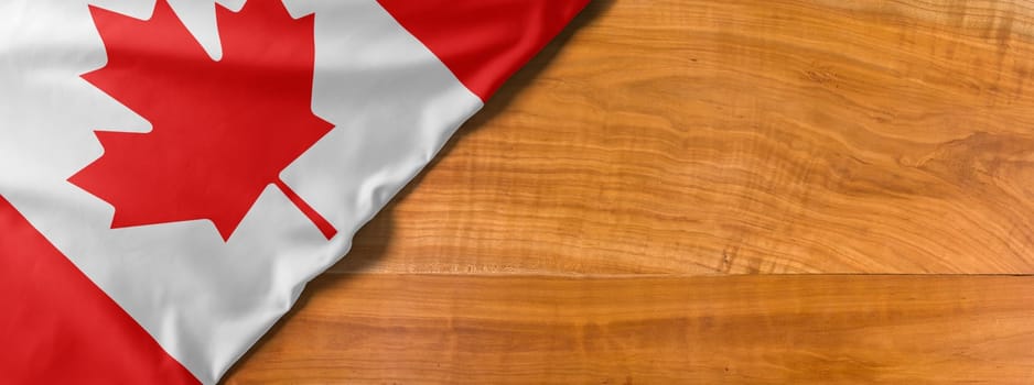 National flag of Canada on a wooden background with copy space