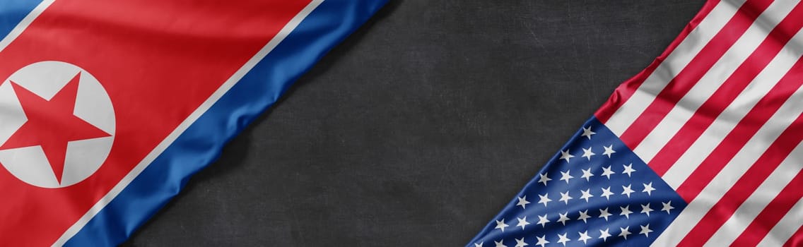 Flags of North Korea and the United States of America with copy space