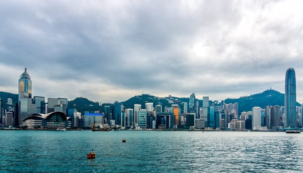 Stormy clouds over Hong Kong bay and island, wide panorama with city scyline, Victoria Peak, China