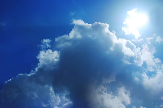 Small bright cloud at the dark cloudy sky
