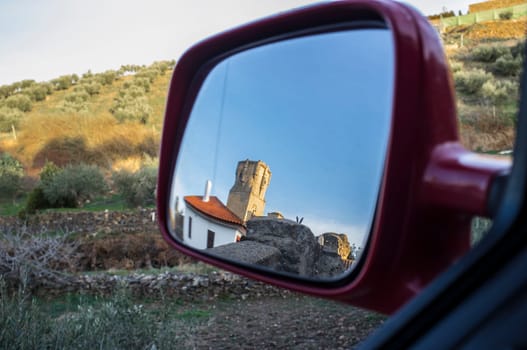 Belalcazar Castle in my car rear mirror. Travel and heritage concept