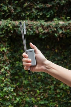 Hand on reusable collapsible drinking straw, stock photo