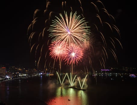 Big firework on the sky at Pattaya coast with cityscape background, Thailand