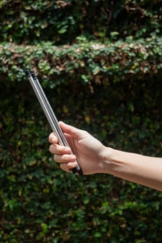 Hand on reusable collapsible drinking straw, stock photo