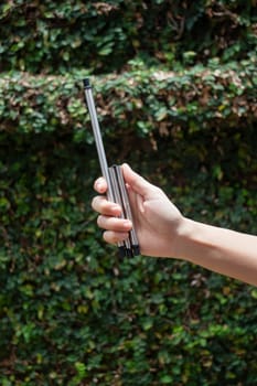 Hand on reusable collapsible drinking straw, stock photo