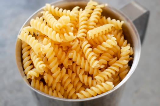 Fusili pasta in stainless container, stock photo