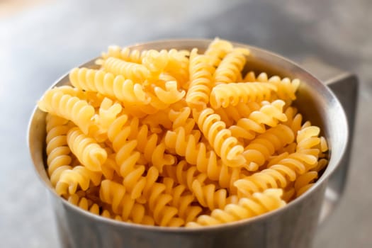 Fusili pasta in stainless container, stock photo