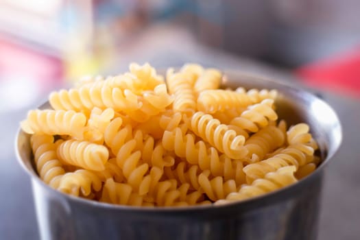 Fusili pasta in stainless container, stock photo