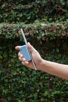 Hand on reusable collapsible drinking straw, stock photo