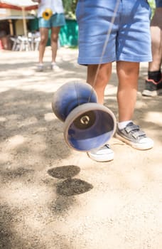 Children learning to use diabolo in the park. Classic games for children concept