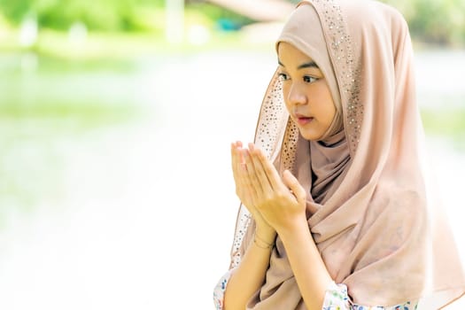 Young Adult teenager Woman making Duas for Muslim god blessing prayer.