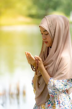 Young Adult teenager Woman making Duas for Muslim god blessing prayer.