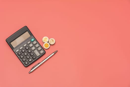 Stack of coin and calculator with copy space. Accounting and business concept.