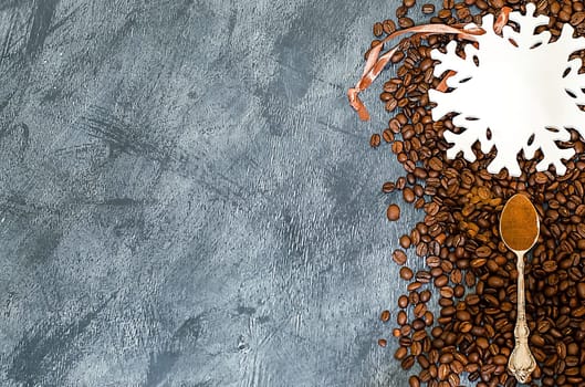 A Christmas background with coffee grains and a large white snowflake with place for text. Top view