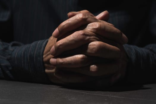 Hand of man while praying for religion. Concept peace and life.
