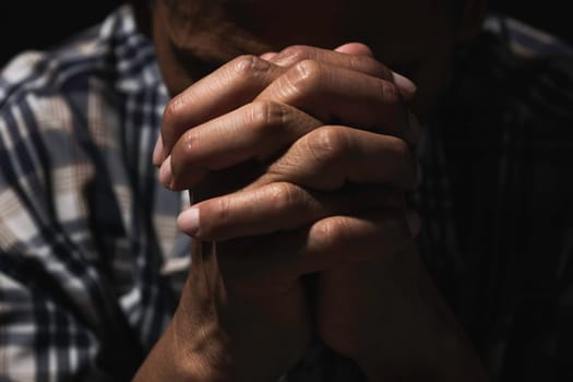 Hand of man while praying for religion. Concept peace and life.