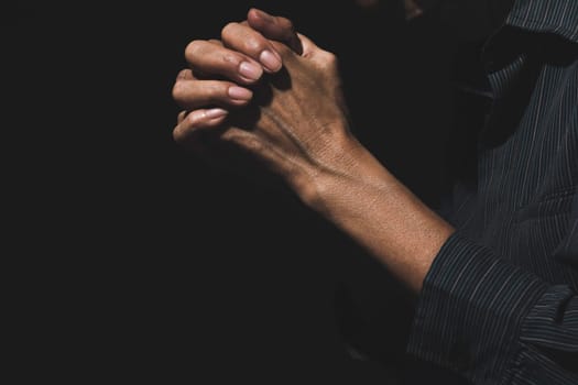 Hand of man while praying for religion. Concept peace and life.