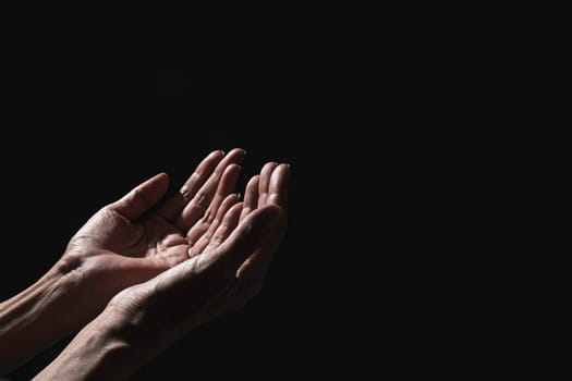 Hand of man while praying for religion. Concept peace and life.