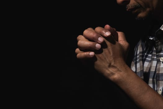 Hand of man while praying for religion. Concept peace and life.