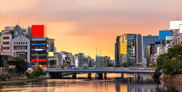 Panorama Fukuoka old town along naka river at Nakasukawabata sunset twilight. This area is favorite for tourist for Fukuoka Yatai, street Food stall,  for hangout at night.