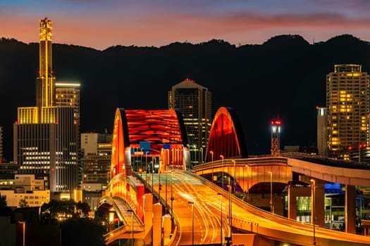 Sunset twilight monorail track and highway red bridge to Kobe downtown Hyogo Kansai Japan