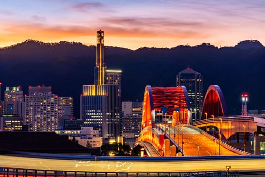 Sunset twilight monorail track and highway red bridge to Kobe downtown Hyogo Kansai Japan