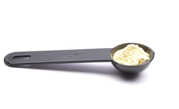 Lupin flour in measuring spoon on white background