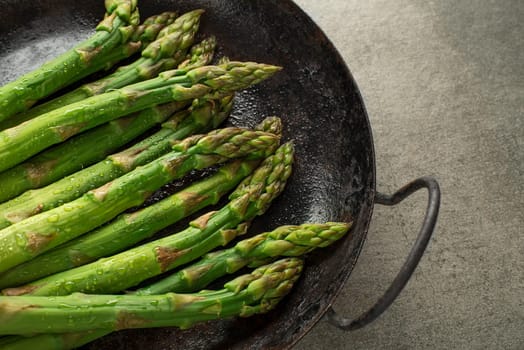 Fresh of green Asparagus. Cooking healthy meal in pan. Bunches of green asparagus