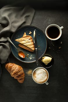Breakfast served with croissant, coffee, jam and butter. Continental breakfast table