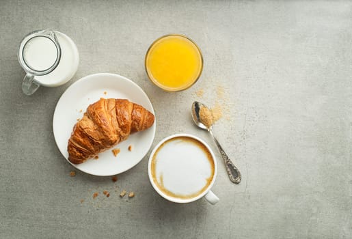 Breakfast served with croissant and coffee. Continental breakfast table