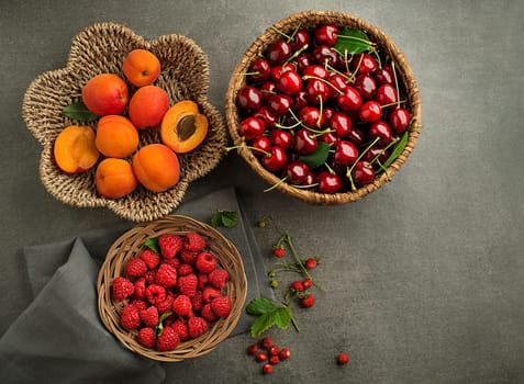 Assorted fruits with green leaf close up. Healthy food with fresh fruit and berries.